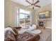 Inviting living room with a fireplace, plush seating, and a sliding glass door to the backyard at 32 Cerchio Basso, Henderson, NV 89011