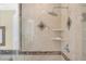 Modern shower with elegant tile work, built-in shelves, and a sleek glass door, creating a spa-like experience at 32 Cerchio Basso, Henderson, NV 89011