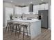 Modern kitchen with white cabinets, stainless steel appliances, and an island with seating at 3434 Oristano Ln, Henderson, NV 89044