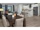 Open-concept living room and kitchen area with hardwood floors and large windows at 3434 Oristano Ln, Henderson, NV 89044