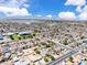 An expansive aerial view of a community featuring homes, pools, green spaces, and mountain ranges at 3845 S Torrey Pines Dr, Las Vegas, NV 89103