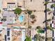 Overhead shot capturing backyards with pools, surrounding properties, and desert landscape in a neighborhood at 3845 S Torrey Pines Dr, Las Vegas, NV 89103