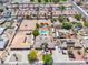 Aerial view of properties featuring back yard pools, vacant lots, and desert landscaping in a suburban setting at 3845 S Torrey Pines Dr, Las Vegas, NV 89103