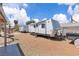 Backyard featuring multiple trailers, offering recreational and storage possibilities, set on a gravel lot at 3845 S Torrey Pines Dr, Las Vegas, NV 89103