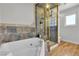 Bathroom boasting a tiled shower with glass door and jetted tub at 3845 S Torrey Pines Dr, Las Vegas, NV 89103