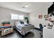 Bright bedroom with hardwood floors, desk, and comfortable chair; perfect space to relax at 3845 S Torrey Pines Dr, Las Vegas, NV 89103