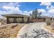 Stunning single-story home with a stone and wood fence, and a spacious driveway at 3845 S Torrey Pines Dr, Las Vegas, NV 89103