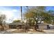 Single-story home with lush landscaping, stone accents, a private wooden fence and a spacious driveway at 3845 S Torrey Pines Dr, Las Vegas, NV 89103