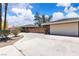 Single-story home with stone accents, a private wooden fence and a long spacious driveway at 3845 S Torrey Pines Dr, Las Vegas, NV 89103