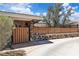 Charming single-story home featuring a wooden fence atop a stone wall and lush landscaping at 3845 S Torrey Pines Dr, Las Vegas, NV 89103