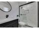 Stylist bathroom showcasing a marble tiled shower with matte black fixtures and a glass door at 4393 Swandale Ave, Las Vegas, NV 89121