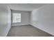 A bedroom featuring neutral carpet, light walls, a large window, and a closet at 4393 Swandale Ave, Las Vegas, NV 89121