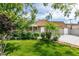 Inviting single-story home featuring lush landscaping, a well-manicured lawn, and a classic design at 4393 Swandale Ave, Las Vegas, NV 89121
