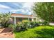 Charming single-story home boasts a lush front yard with mature plants, enhancing curb appeal at 4393 Swandale Ave, Las Vegas, NV 89121