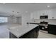 Kitchen with island, stainless steel appliances, and open concept to the living room at 4393 Swandale Ave, Las Vegas, NV 89121