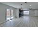 Open-concept living area with a fireplace, wood floors, and lots of natural light at 4393 Swandale Ave, Las Vegas, NV 89121
