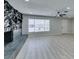 Bright living room showcasing a stone fireplace, ceiling fan, and large window at 4393 Swandale Ave, Las Vegas, NV 89121