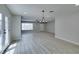 Bright living room with wood flooring, large windows, and neutral paint at 4393 Swandale Ave, Las Vegas, NV 89121