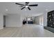Open-concept living space with modern light fixtures and a glimpse of the updated kitchen at 4393 Swandale Ave, Las Vegas, NV 89121