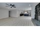 Open-concept living room leading into a modern kitchen with stainless steel appliances and dark island at 4393 Swandale Ave, Las Vegas, NV 89121