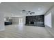 Bright living room featuring a stone fireplace, ceiling fan, and wood-look flooring at 4393 Swandale Ave, Las Vegas, NV 89121