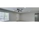 Clean living room features a ceiling fan, neutral walls, and a bright window view at 4393 Swandale Ave, Las Vegas, NV 89121