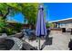 The backyard features a patio with a seating area and is shaded by mature trees at 444 Flores Cir, Las Vegas, NV 89123