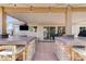 Covered backyard bar area with grill and TV, with bar seating at 444 Flores Cir, Las Vegas, NV 89123
