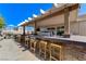 Backyard bar area with stools and outdoor grill, perfect for entertaining at 444 Flores Cir, Las Vegas, NV 89123