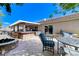 Spacious backyard featuring an outdoor bar, fire pit, and comfortable seating for entertaining at 444 Flores Cir, Las Vegas, NV 89123