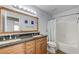 Spacious bathroom with a double vanity, granite countertop, and a shower with a tub at 444 Flores Cir, Las Vegas, NV 89123
