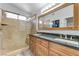 Luxurious bathroom with double vanity, granite countertop, and glass enclosed shower at 444 Flores Cir, Las Vegas, NV 89123