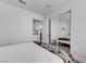 Cozy bedroom features light walls and a mirrored closet with access to the kitchen at 444 Flores Cir, Las Vegas, NV 89123