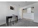 Bedroom with gray carpet, a window with blinds, and a dark table and chair at 444 Flores Cir, Las Vegas, NV 89123