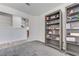 Bedroom features gray carpet, two bookshelves, a window and access to kitchen at 444 Flores Cir, Las Vegas, NV 89123