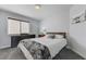 Comfortable bedroom features natural light, a cow art print and neutral decor at 444 Flores Cir, Las Vegas, NV 89123