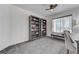 Bedroom with gray carpet, a window with blinds, and gray bookshelves at 444 Flores Cir, Las Vegas, NV 89123