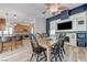 Open-concept dining room featuring a wooden table, fireplace, and adjacent modern kitchen at 444 Flores Cir, Las Vegas, NV 89123
