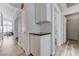 Hallway features light colored wood floors, a gray countertop, and multiple doorways at 444 Flores Cir, Las Vegas, NV 89123