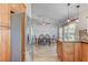 Open concept: kitchen with granite counters and wood cabinets open to dining and living spaces at 444 Flores Cir, Las Vegas, NV 89123