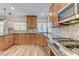 Modern kitchen featuring stainless steel stove, granite countertops, and updated cabinetry at 444 Flores Cir, Las Vegas, NV 89123