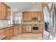 Well-lit kitchen with granite countertops, stainless steel appliances, and ample wood cabinetry at 444 Flores Cir, Las Vegas, NV 89123