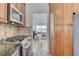 Charming kitchen featuring stainless steel appliances, granite countertops, and wood cabinetry at 444 Flores Cir, Las Vegas, NV 89123