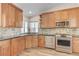 Well-lit kitchen featuring stainless steel appliances, granite countertops, and ample wood cabinetry at 444 Flores Cir, Las Vegas, NV 89123