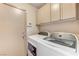 Functional laundry room with overhead cabinets, a washer and dryer at 444 Flores Cir, Las Vegas, NV 89123