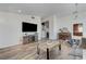 Spacious living room with hardwood floors and a large television for entertaining guests at 444 Flores Cir, Las Vegas, NV 89123
