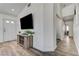 Bright living room features a TV, a decorative console table, and a white front door at 444 Flores Cir, Las Vegas, NV 89123