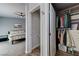 A view of the main bedroom featuring calming colors, ceiling fan and a walk-in closet with closet toilet at 444 Flores Cir, Las Vegas, NV 89123