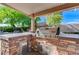 A stainless steel grill set in a stone-finished counter with additional drawers for storage at 444 Flores Cir, Las Vegas, NV 89123
