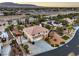An aerial view of a neighborhood showcasing a two-story home with desert landscaping at 4471 Borrego Springs Way, Las Vegas, NV 89129